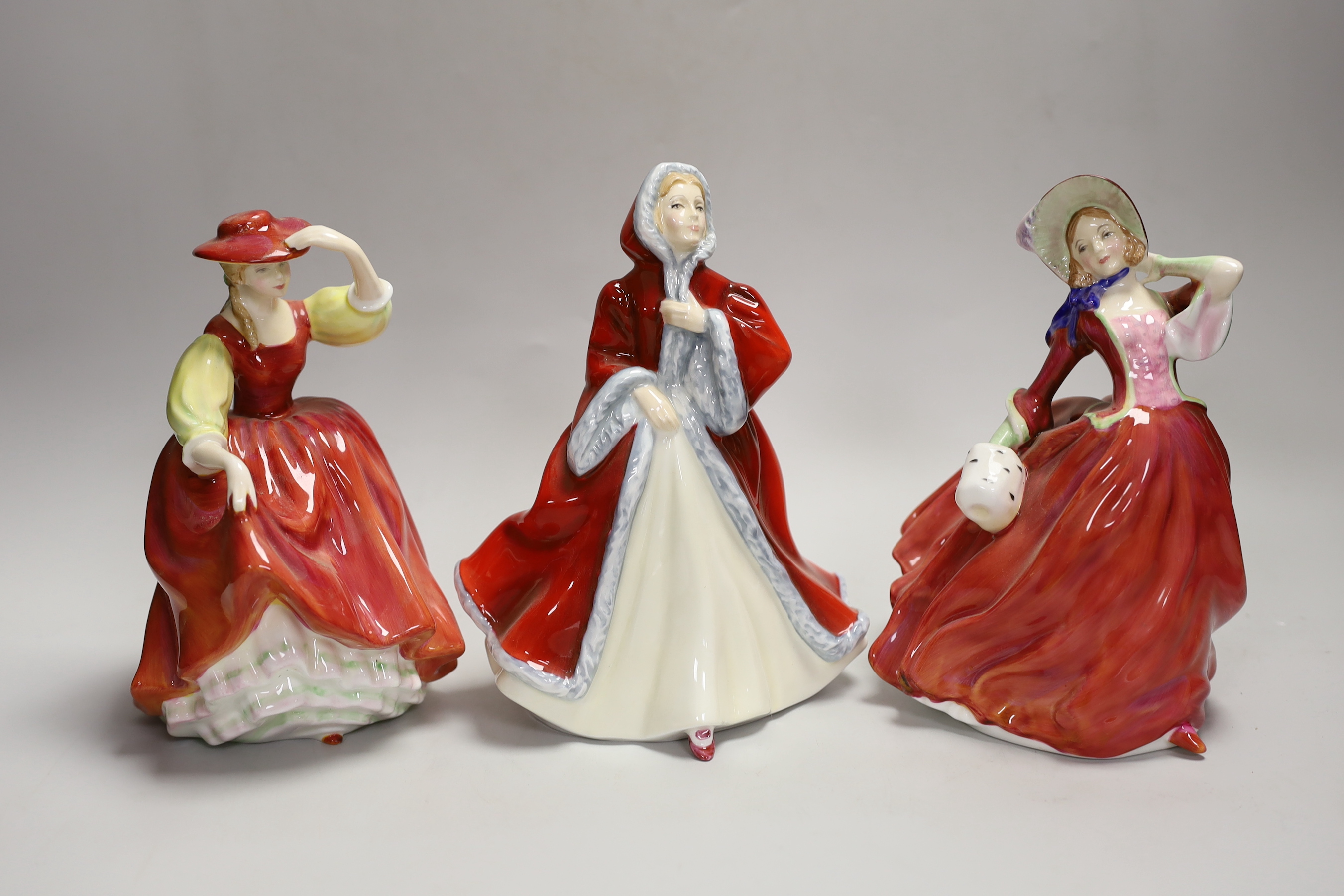 Three Royal Doulton figures: Rachel HN2936, Buttercup HN2399, Autumn Breezes HN1934, tallest 20cm